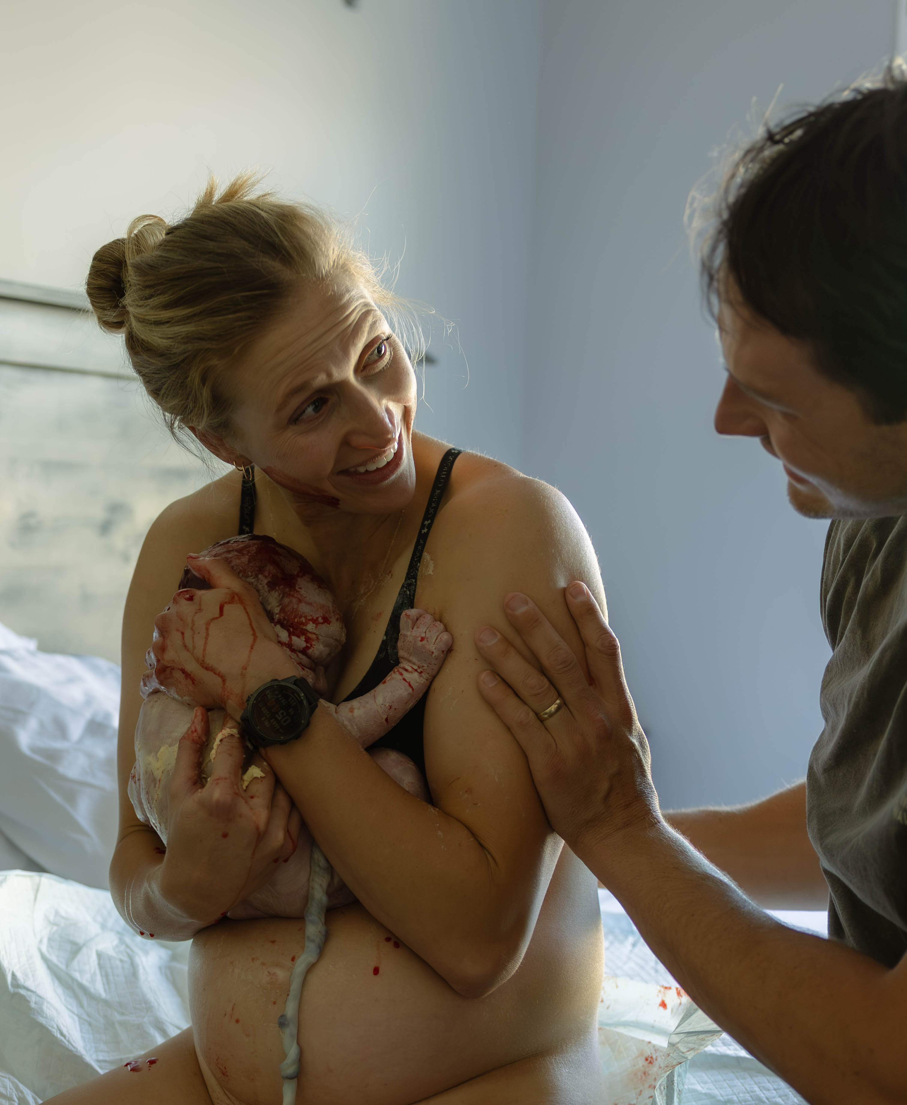 Tender moment between parents and their newborn baby
